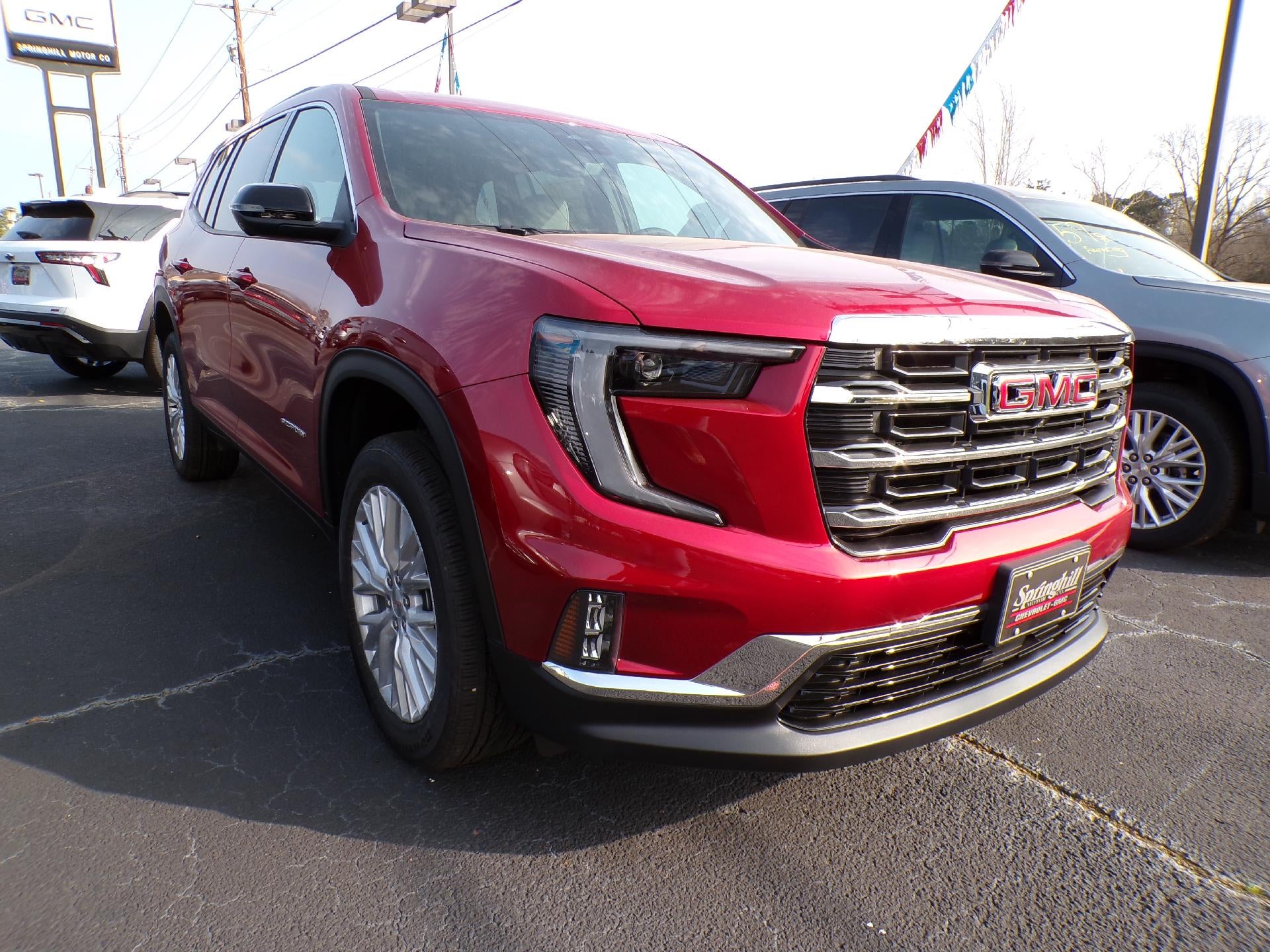 2026 GMC Acadia Elevation in Volcanic Red Tintcoat — front three-quarter view
