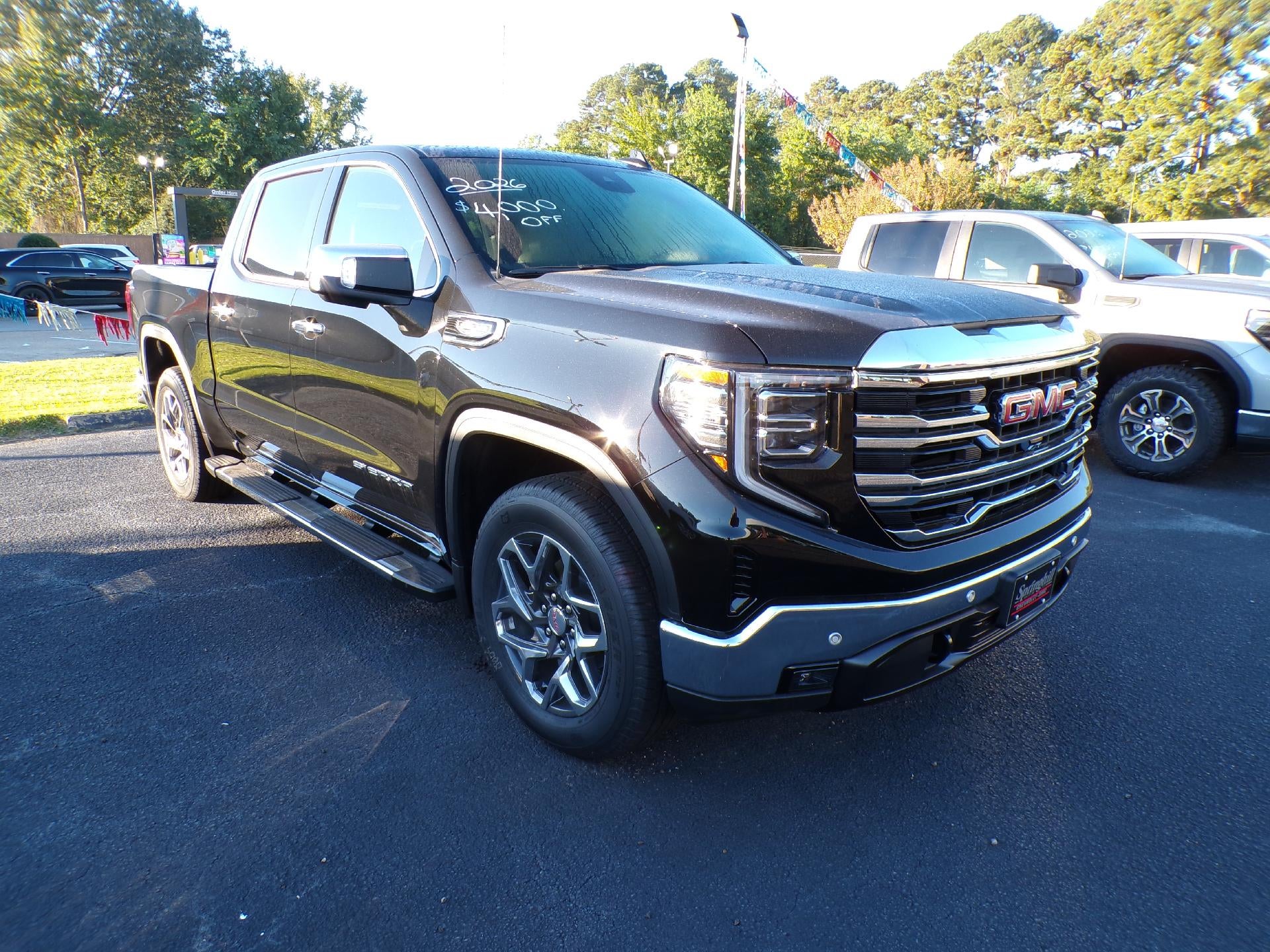 2026 GMC Sierra 1500 SLT in Onyx Black — front three-quarter view